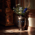 Artisan bronze urn with antique patina finish filled with fresh flowers